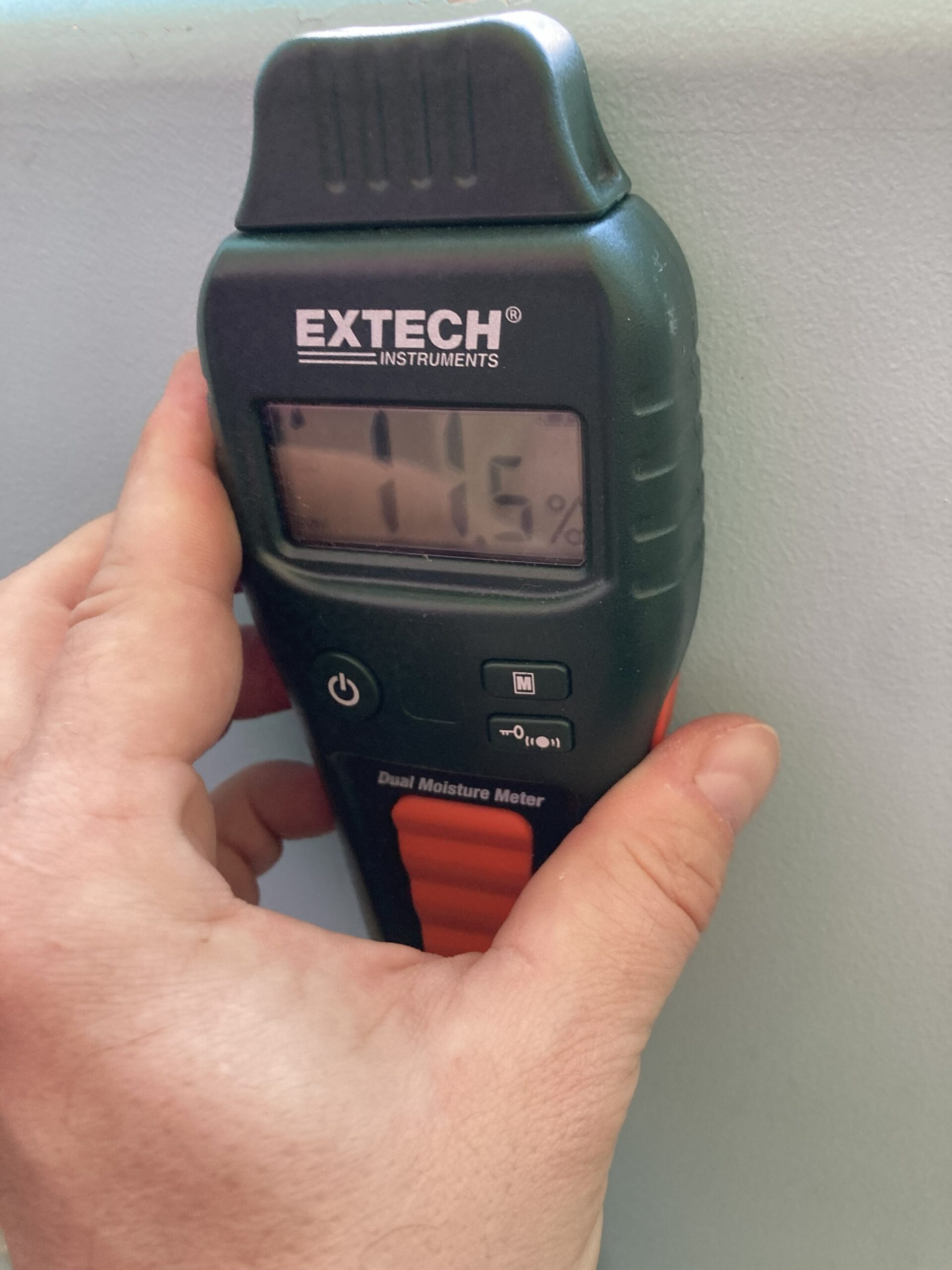 Moisture meter testing wall moisture